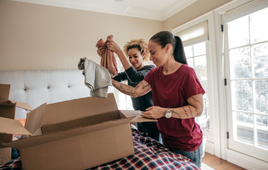 women sorting through clothing to donate