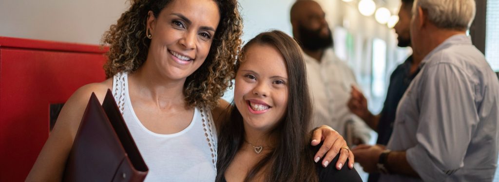 Woman and student pose together smiling