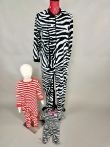 Child-sized and Adult Mannequins dressed in one-piece Pajama sets from Ohio Valley Goodwill